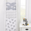 Three Nojo Dumbo printed muslin swaddles displayed on a white rack, featuring Dumbo designs and soft gray tones.