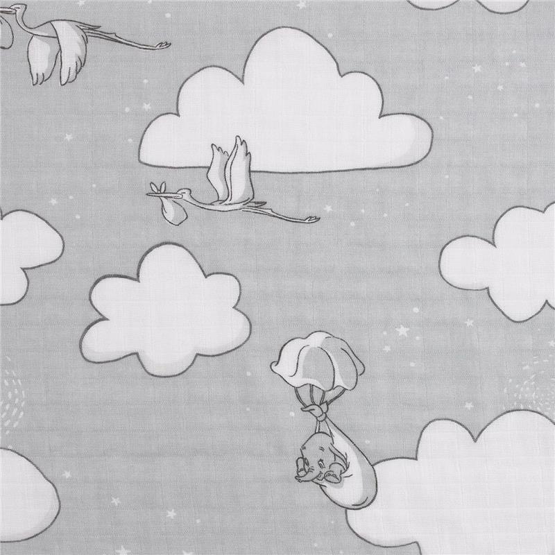 Muslin swaddle featuring grey clouds, flying storks carrying bundles, and a Dumbo character in a parachute.