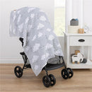 Muslin swaddle blanket featuring Dumbo and cloud prints draped over a stroller in a bright, cozy room.