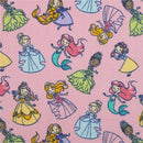 Colorful printed muslin swaddles featuring cartoon princesses and mermaids on a pink background.