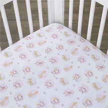 Fitted crib sheet featuring playful animal designs, including monkeys and giraffes, on a soft pink background.