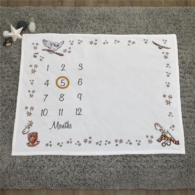 Milestone blanket featuring Harry Potter themes, with numbers 1 to 12, stars, and iconic symbols including a golden snitch.