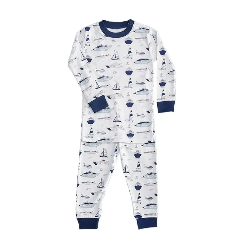 Long sleeve pajamas for baby boys featuring a nautical print with boats and sailboats in blue and white.