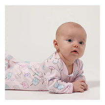 Cotton candy-print baby girl footie in soft cotton, featuring pastel colors and a zipper closure, worn by a crawling infant.