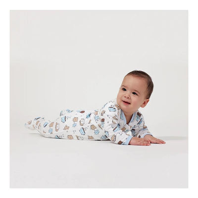 Blue zipper footie featuring a smores pattern, worn by a smiling baby posing on a white background.