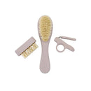 Baby grooming kit featuring a soft-bristled brush, comb, and safety scissors in a light pink color.