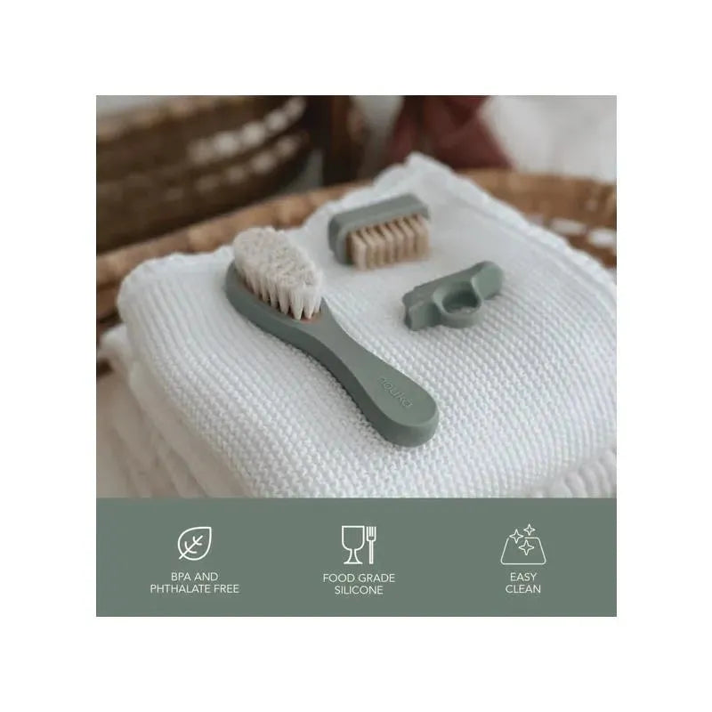 Nouka Baby Grooming Kit in Lily Blue featuring a soft brush, comb, and nail clipper on a white textured towel.