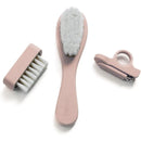 Baby grooming kit by Nouka in soft blush, including a soft brush, comb, and nail clipper.