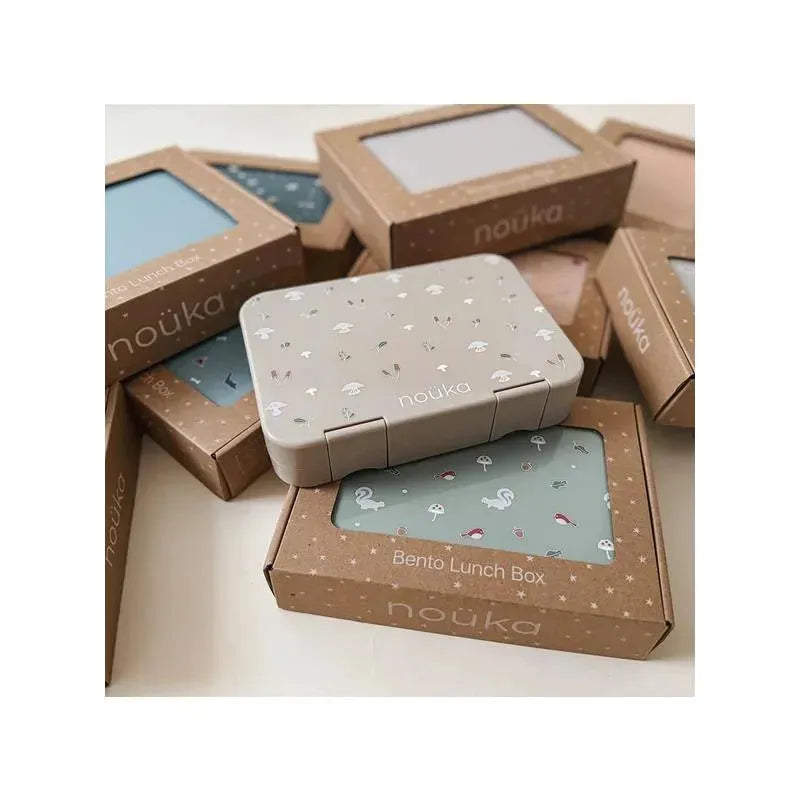 Bento lunch box by Nouka in light beige with floral patterns, surrounded by various packaging boxes in soft colors.