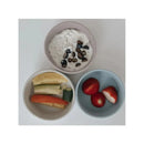 Suction bowls in Lily Blue and pale pink colors contain yogurt with seeds and assorted fruit and vegetable slices.