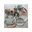 Suction bowl set in Lily Blue featuring assorted plates, cups, spoons, and a bib in soft pastel colors.