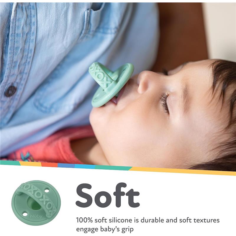 Silicone pacifier held by a baby, featuring a soft green cherry baglet, emphasizing durability and comfort.