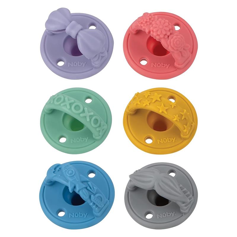 Six colorful silicone pacifiers from Nuby featuring various designs, including bows, flowers, and stars, suitable for infants 0M+.
