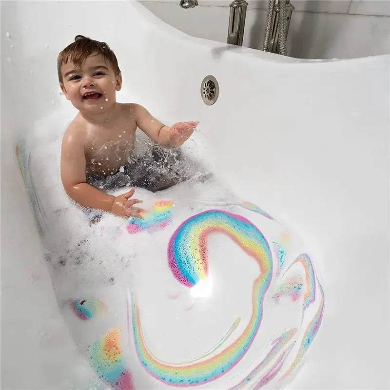 A happy child sits in a bubbly bathtub, playing with colorful foam creating a rainbow pattern in the water.