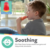 Toddler enjoying a silicone popsicle mold, tasting a red frozen treat to soothe sore gums.