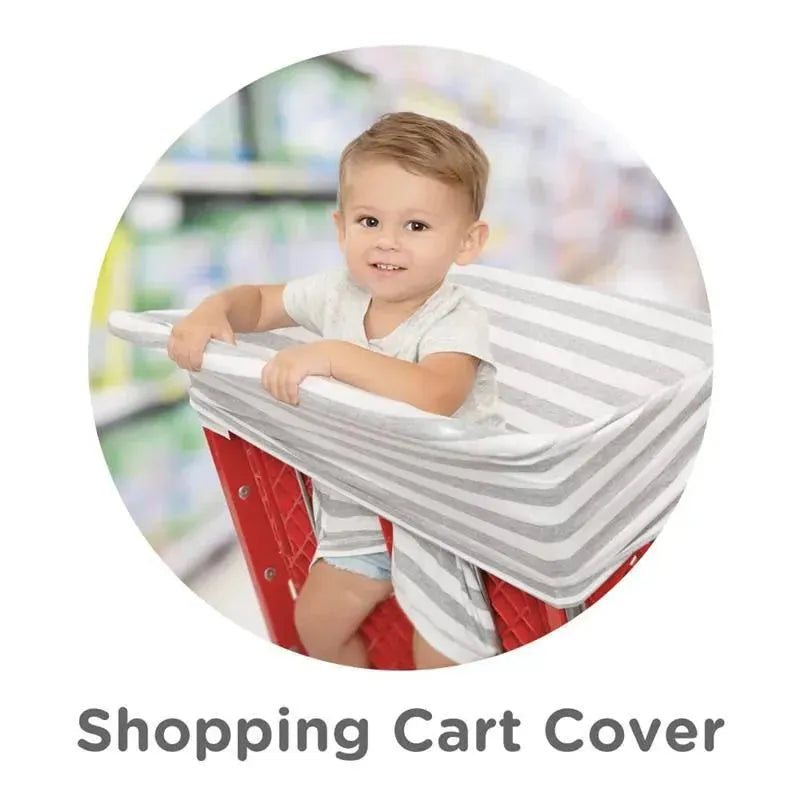 Shopping cart cover in chevron print with a smiling child seated inside a shopping cart.