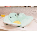 Nuby Bathing Turtle baby bath sink insert in soft mint green with a smiling turtle face and yellow shell, designed for infant bathing.