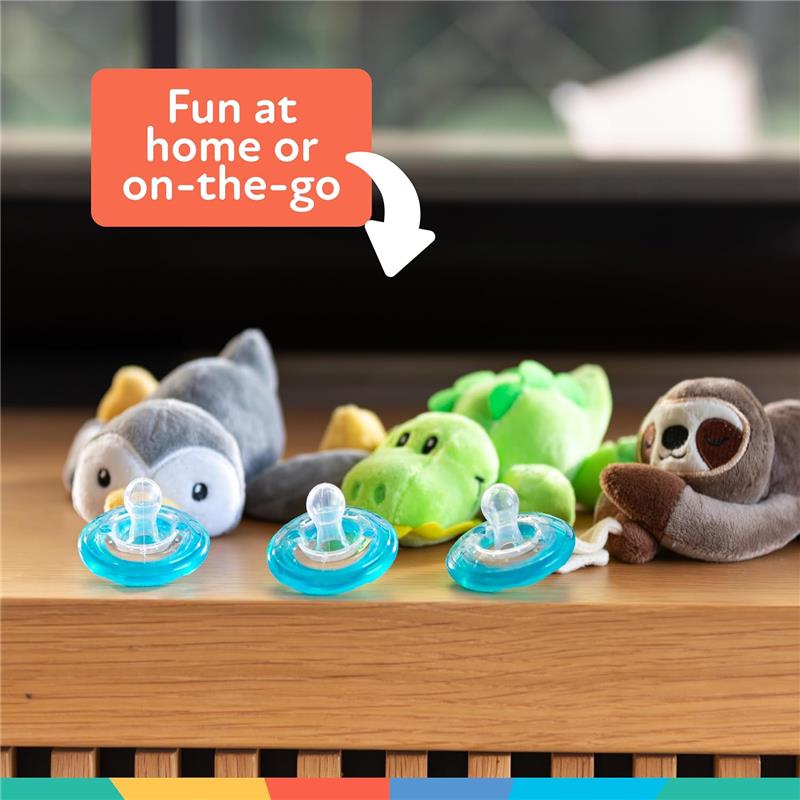 Nuby Calming Natural Flex Snuggleez Pacifiers with plush animal toys, including a sloth, penguin, and alligator, on a table.
