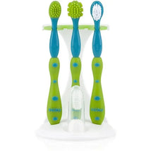 Nuby Dr Talbots 4 Pc Tooth & Gum Care Set in aqua and green, featuring three toothbrushes and a finger toothbrush on a stand.
