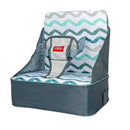 Collapsible Nuby booster seat with gray fabric exterior and chevron-patterned padded seat, includes safety straps.