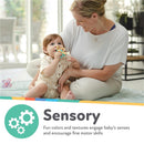 Flower-shaped blue and aqua teething toy held by a baby, while a smiling mother interacts nearby.