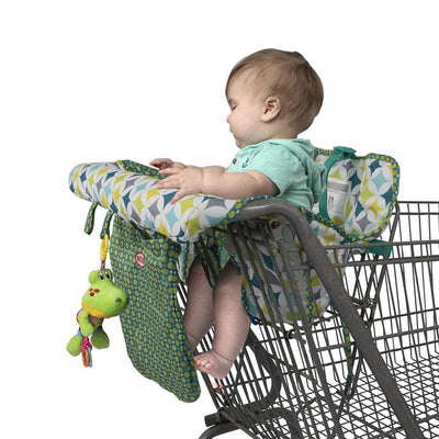 Nuby shopping cart and high chair cover in diamond print, featuring a baby seated with a toy attached.