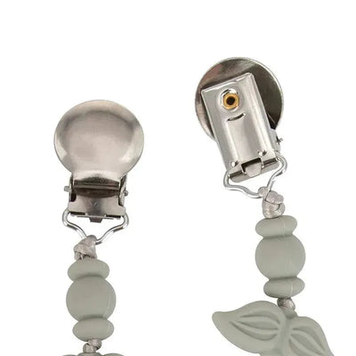 Silicone pacifier clip by Nuby featuring a mustache design, with dual metal clips and gray beads.