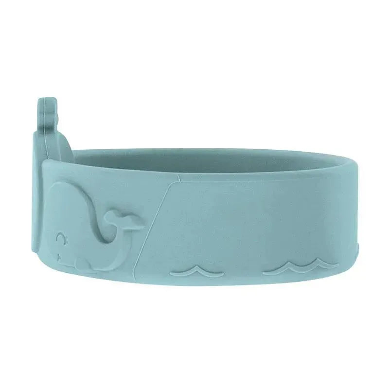 Silicone whale-shaped feeding bowl in blue, featuring carved details like waves and a whale design.