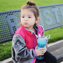 Girl wearing a pink and gray jacket sits on a bench, holding a Nuby Thirsty Kids Flip It Reflex water bottle in aqua.