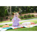 Toddler in a purple outfit sitting on a colorful blanket, holding a Tritan gray star sippy cup, surrounded by plush toys.