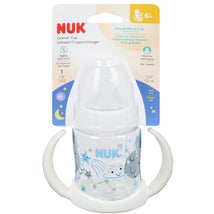 Glow-in-the-dark Nuk learner cup with soft silicone spout, 5 oz capacity, featuring fun space-themed graphics and easy-grip handles.