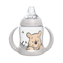 Nuk Winnie The Pooh 5 oz learner cup with a clear body, soft spout, and handles featuring Winnie the Pooh design.