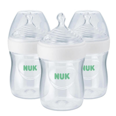 Three NUK Simply Natural 5 oz baby bottles with slow flow nipples, featuring clear plastic with green NUK logo.