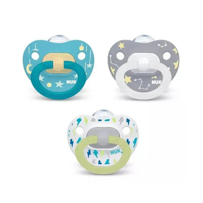 Three NUK pacifiers in blue, gray, and white, showcasing star and lightning designs, for ages 6 to 18 months.