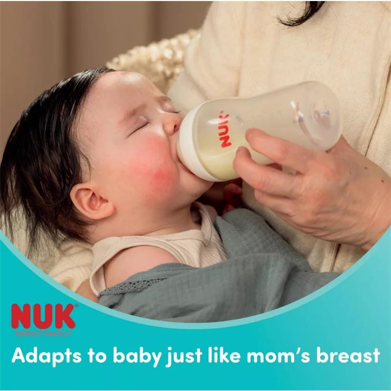 NUK Perfect Match baby bottle being fed to an infant, with text highlighting its adaptability to babies.