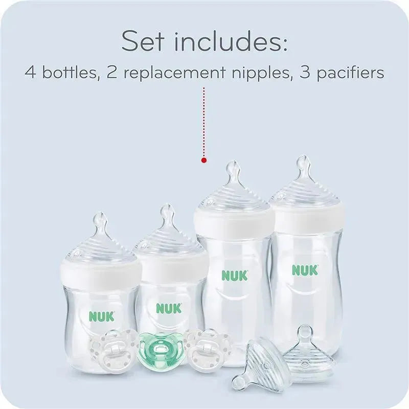 4 NUK baby bottles, 2 replacement nipples, and 3 pacifiers on a light blue background.