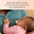 Breast-like NUK pacifier held by a sleeping baby, with a curved shield for comfort.