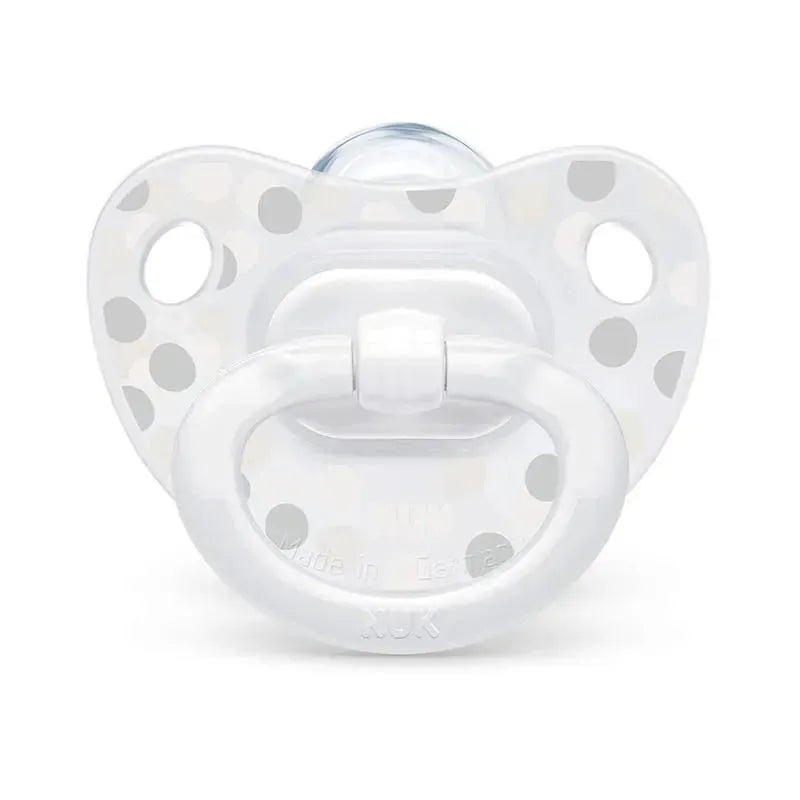 Pacifier with a white and polka dot design, part of the Nuk Simply Natural Baby Bottles Gift Set.