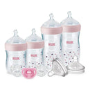 Nuk Simply Natural Baby Bottles gift set in pink featuring 4 bottles, 3 pacifiers, and 2 replacement nipples.