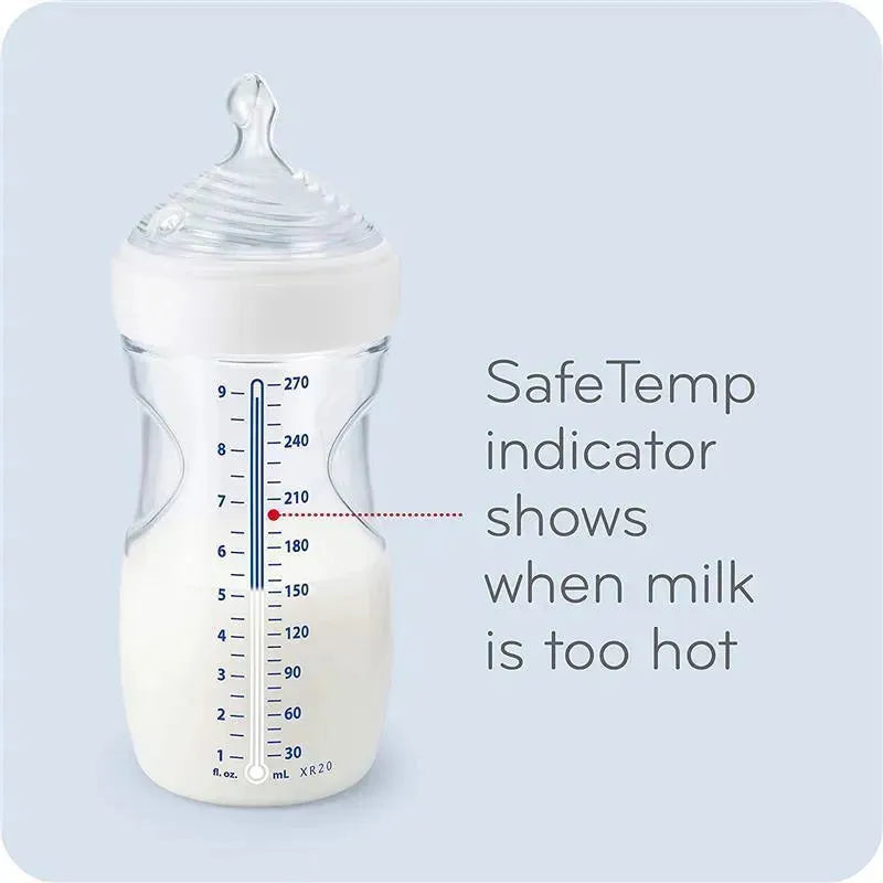 Nuk Simply Natural Baby Bottle displaying SafeTemp indicator to show milk temperature, with measurement markings, filled with milk.