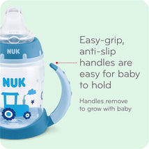 Glow-in-the-dark Nuk learner cup with easy-grip, anti-slip handles; features a tractor design and is 5 oz.