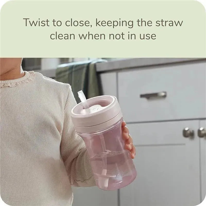 Nature Everlast Weighted Straw Cup in pink held by a child, with a twist-to-close feature visible to keep the straw clean.