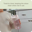 Nature Everlast Weighted Straw Cup in pink held by a child, with a twist-to-close feature visible to keep the straw clean.
