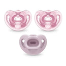 Three pink Nuk pacifiers sized for girls, featuring a rounded shape and a comfortable design for infants.