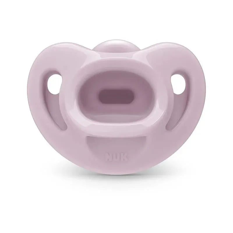 Nuk pacifier in soft pink color, size 1, designed for girls, featuring a comfortable shape and ventilation holes.