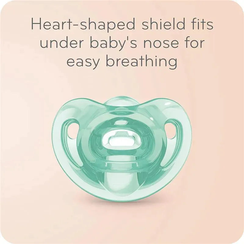 Heart-shaped pacifier designed for easy breathing, featuring a clear mint green shield and a round nipple.