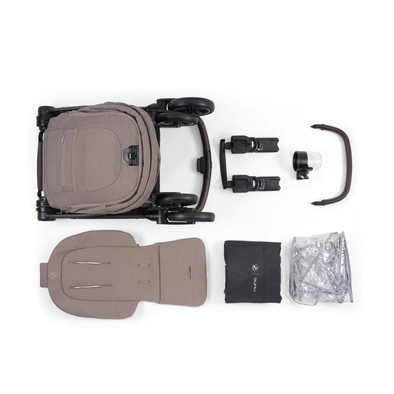 Nuna BMW Swiv Stroller bundle in Umber with bassinet, stand, seat pad, and accessories, arranged flat on white background.