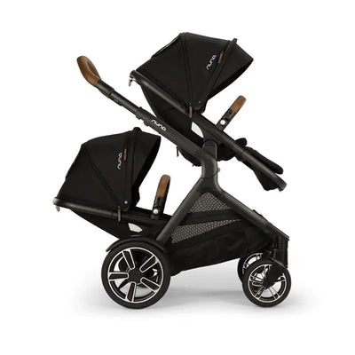 Nuna DEMI next Sibling Seat in Caviar, featuring two adjustable canopies, a sleek black design, and modern wheels.