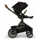Nuna DEMI Next Stroller in Caviar color with a stylish, adjustable seat, black canopy, and large undercarriage storage.