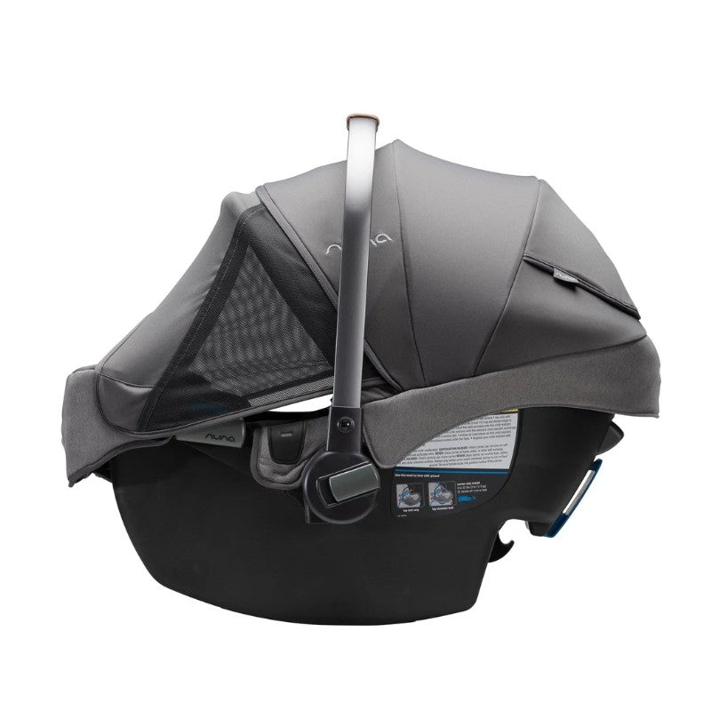 Nuna Pipa Rx infant car seat in granite color, featuring a protective canopy and a safety handle.